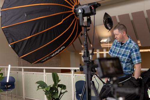 A worker checks lighting and cameras